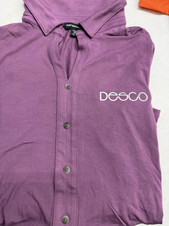 DESCO logo embroidered on a purple button-up shirt
