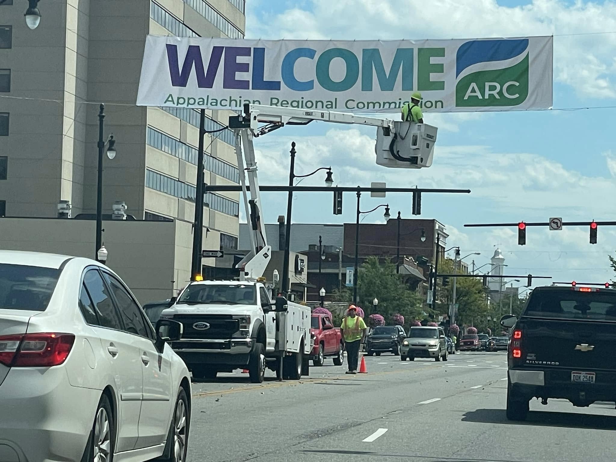 Appalachian Regional Commission welcome banner being hung across a downtown street