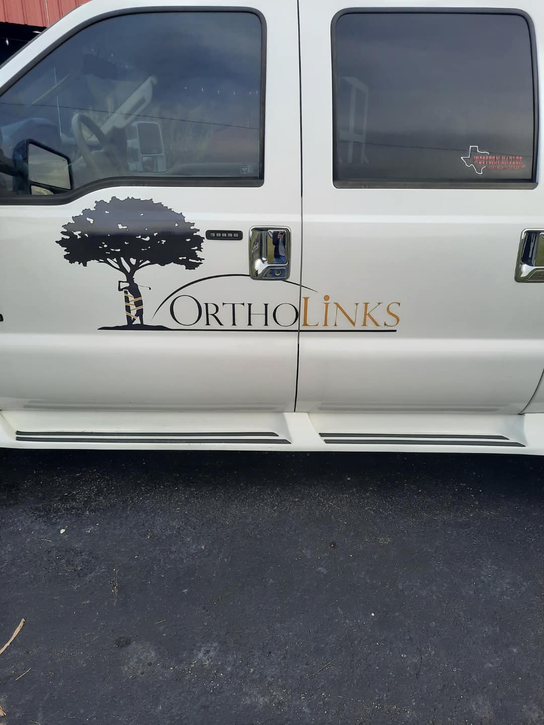 OrthoLinks logo vinyl lettering on a white pickup truck door